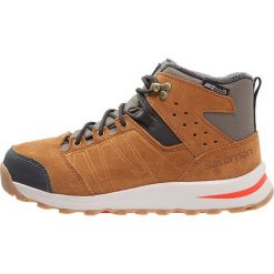 Salomon UTILITY TS CSWP Śniegowce swamp/rawhide/lava orange. Czerwone buty zimowe damskie Salomon, z gumy. W wyprzedaży za 350,10 zł.
