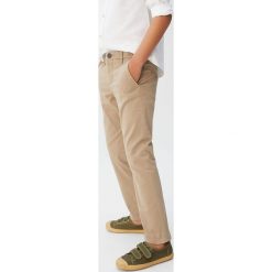 Mango Kids - Spodnie dziecięce Piccolo5 110-164 cm. Niebieskie spodnie chłopięce Mango Kids, bez wzorów, z elastanu, casualowe. Za 69,90 zł.