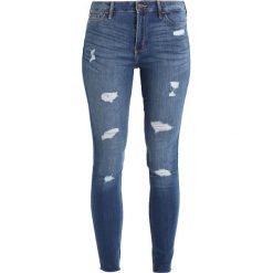 Hollister Co. STRECH HIGHRISE SUPER SKINNY JEANS Jeansy Slim Fit medium wash. Szare rurki damskie marki Hollister Co., z elastanu. W wyprzedaży za 199,20 zł.
