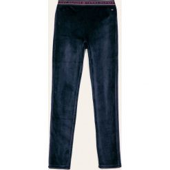 Tommy Hilfiger - Spodnie dziecięce 128-176 cm. Niebieskie spodnie dziewczęce TOMMY HILFIGER, z aplikacjami, z elastanu. Za 229,90 zł.