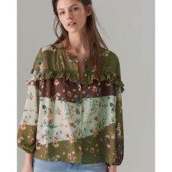 Bluzka oversize z falbaną - Brązowy. Pomarańczowe bluzki damskie marki Mohito, bez wzorów, bez kołnierzyka, bez rękawów. Za 119,99 zł.