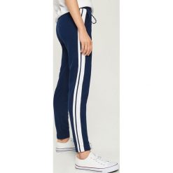 Spodnie dresowe z lampasami - Granatowy. Niebieskie spodnie dresowe damskie Sinsay, s, z dresówki. Za 49,99 zł.