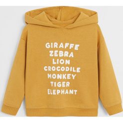 Mango Kids - Bluza dziecięca Monkey 80-104 cm. Żółte bluzy chłopięce Mango Kids, z nadrukiem, z bawełny, bez rękawów, z kapturem. Za 69,90 zł.