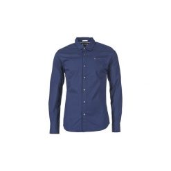 Koszule z długim rękawem Tommy Jeans KANTERMI. Niebieskie koszule męskie Tommy Jeans, s, bez wzorów, z jeansu, bez kołnierzyka, z długim rękawem. W wyprzedaży za 262,70 zł.