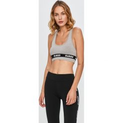 Guess Jeans - Biustonosz sportowy. Czerwone biustonosze sportowe damskie Guess Jeans, s, z nadrukiem, z elastanu. Za 169,90 zł.