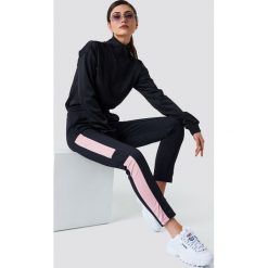 NA-KD Spodnie sportowe - Black. Czarne bryczesy damskie marki NA-KD, z poliesteru. Za 133,95 zł.