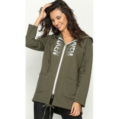 Khaki Bluza Neva. Brązowe bluzy damskie marki Born2be, uniwersalny, z nadrukiem, bez rękawów, z kapturem. Za 104,99 zł.