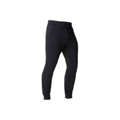 Spodnie dresowe slim Gym & Pilates 560 męskie. Czarne spodnie męskie DOMYOS, xs, bez wzorów, z elastanu. W wyprzedaży za 74,99 zł.
