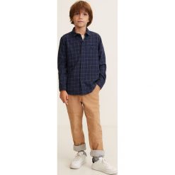 Mango Kids - Koszula dziecięca Jean 110-164 cm. Niebieskie koszule chłopięce marki Mango Kids, w kratkę, z bawełny, klasyczne, z klasycznym kołnierzykiem, z długim rękawem, długie. W wyprzedaży za 49,90 zł.
