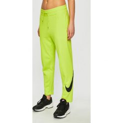 Nike Sportswear - Spodnie. Żółte spodnie damskie Nike Sportswear, s, bez wzorów, z bawełny. Za 229,90 zł.