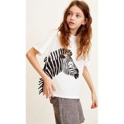 Mango Kids - Top dziecięcy Zebra 110-152 cm. Białe bluzki dziewczęce Mango Kids, z nadrukiem, z bawełny, z okrągłym kołnierzem, z krótkim rękawem, krótkie, bez kaptura. Za 59,90 zł.