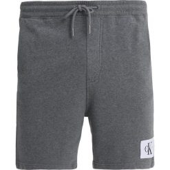 Calvin Klein Jeans HOMEROS SLIM Spodnie treningowe mid grey heather. Szare jeansy męskie slim marki Calvin Klein Jeans. Za 299,00 zł.
