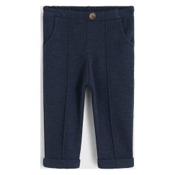 Mango Kids - Spodnie dziecięce Miguel 80-104 cm. Niebieskie spodnie chłopięce Mango Kids, bez wzorów, z poliesteru. W wyprzedaży za 49,90 zł.