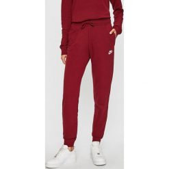 Nike Sportswear - Spodnie. Czerwone spodnie damskie Nike Sportswear, s, bez wzorów, z bawełny, casualowe. W wyprzedaży za 139,90 zł.