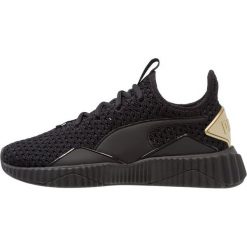 Puma DEFY VARSITY Obuwie treningowe black/metallic gold. Czarne buty sportowe damskie Puma, z materiału. Za 419,00 zł.