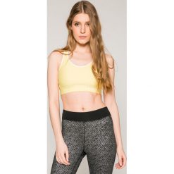 Under Armour - Biustonosz. Żółte biustonosze sportowe damskie marki Under Armour, s, z aplikacjami, z elastanu. W wyprzedaży za 89,90 zł.