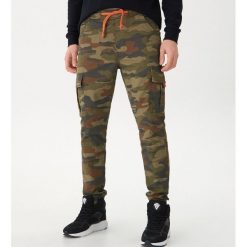 Joggery camo - Beżowy. Brązowe spodnie męskie marki House, s, bez wzorów. Za 139,99 zł.