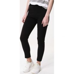 Czarne Legginsy Adorned. Czarne legginsy damskie Born2be, bez wzorów, z tkaniny. Za 29,99 zł.