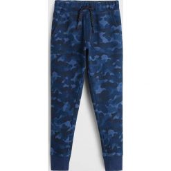 Mango Kids - Spodnie dziecięce Fossil6 110-164 cm. Szare spodnie chłopięce Mango Kids, bez wzorów, z elastanu. W wyprzedaży za 45,90 zł.