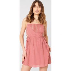 Debiflue x NA-KD Sukienka mini ze sznurowaniem - Pink. Różowe sukienki damskie marki Debiflue x NA-KD, z haftami, bez kołnierzyka, bez rękawów, mini. W wyprzedaży za 80,97 zł.