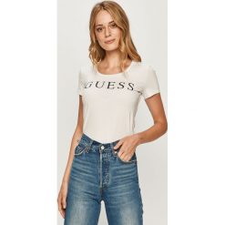 Guess Jeans - T-shirt. Żółte bluzki damskie Guess Jeans, s, z aplikacjami, z elastanu, casualowe, z okrągłym kołnierzem, z krótkim rękawem. Za 179,90 zł.