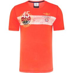 T-shirt AERONAUTICA MILITARE. Pomarańczowe t-shirty męskie Aeronautica Militare, z nadrukiem, z bawełny, militarne, z okrągłym kołnierzem. W wyprzedaży za 205,00 zł.