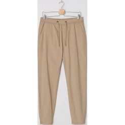 Joggery z organicznej bawełny - Beżowy. Brązowe spodnie męskie House, s, bez wzorów, z bawełny. Za 99,99 zł.