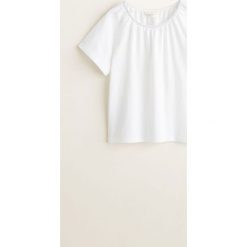 Mango Kids - Top dziecięcy Amanda 110-164 cm. Białe bluzki dziewczęce Mango Kids, bez wzorów, z bawełny, z okrągłym kołnierzem, z krótkim rękawem, krótkie, bez kaptura. Za 49,90 zł.