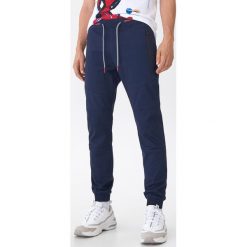 Spodnie jogger slim - Granatowy. Niebieskie spodnie męskie House, s, bez wzorów. Za 129,99 zł.