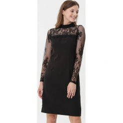 Czarna Sukienka Pretty Unique. Czarne sukienki damskie Born2be, na zimę, s, bez wzorów, z tkaniny, bez kołnierzyka, bez rękawów, mini. Za 79,99 zł.