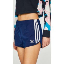 Adidas Originals - Szorty. Niebieskie spodenki sportowe damskie marki adidas Originals, z poliesteru, sportowe. Za 129,90 zł.