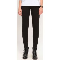 LEGGINSY DAMSKIE MATOWE. Czarne legginsy marki TROLL, s, z dzianiny. W wyprzedaży za 29,99 zł.