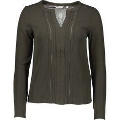 Bluzka "Oye" w kolorze khaki. Brązowe bluzki damskie NAF NAF, xs, w koronkowe wzory, z koronki, klasyczne, bez kołnierzyka, bez rękawów. W wyprzedaży za 55,95 zł.