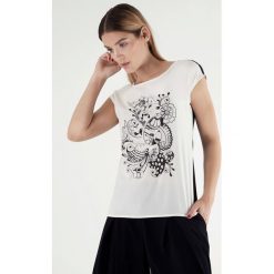 Bluzka w kolorze biało-czarnym. Czarne bluzki damskie Far Far Fashion, Ryłko by Agnes&Paul, bez wzorów, z okrągłym kołnierzem, bez rękawów. W wyprzedaży za 59,95 zł.