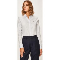 Lacoste - Koszula. Niebieskie bluzki damskie Lacoste, bez wzorów, z elastanu, eleganckie, z klasycznym kołnierzykiem, z długim rękawem. W wyprzedaży za 349,90 zł.