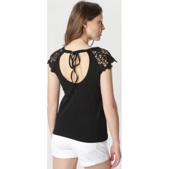 Czarna Bluza Morganoe. Czarne bluzki damskie Born2be, s, bez wzorów, bez kołnierzyka, bez rękawów. W wyprzedaży za 39,99 zł.