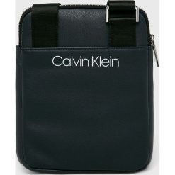 Calvin Klein - Saszetka. Niebieskie torby męskie skórzane Calvin Klein, w paski, ze skóry ekologicznej, casualowe, małe. W wyprzedaży za 199,90 zł.