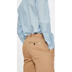 Lacoste - Spodnie. Pomarańczowe spodnie męskie Lacoste, l, z elastanu, casualowe. W wyprzedaży za 269,90 zł.