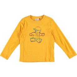 Koszulka "Tiger 114" w kolorze żółtym. Żółte t-shirty chłopięce LEGO Wear, z nadrukiem, z długim rękawem. W wyprzedaży za 42,95 zł.
