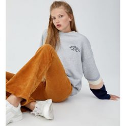 Bluza z haftem i panelami na rękawach. Szare bluzy damskie Pull&Bear, z haftami, bez rękawów, bez kaptura. Za 89,90 zł.