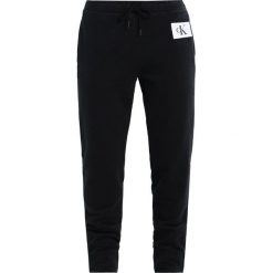 Calvin Klein Jeans PERSIS TRUE ICON TRACK PANT Spodnie treningowe black. Czarne spodnie sportowe damskie Calvin Klein Jeans. W wyprzedaży za 359,20 zł.