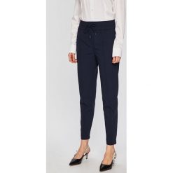 Lacoste - Spodnie. Niebieskie spodnie damskie marki Lacoste, z poliesteru. Za 499,90 zł.