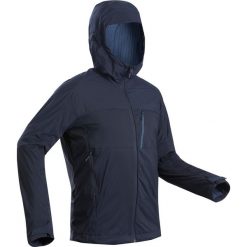Kurtka softshell trekkingowa - TREK 900 WINDWARM męska. Niebieskie kurtki męskie FORCLAZ, s, bez wzorów, z elastanu, bez kaptura, trekkingowe. Za 299,99 zł.