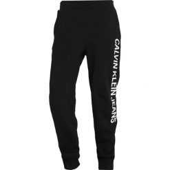Calvin Klein Jeans INSTITUTIONAL SIDE PANTS Spodnie treningowe black. Czarne spodnie dresowe męskie marki Calvin Klein Jeans, xl, z bawełny. Za 419,00 zł.