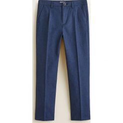 Mango Kids - Spodnie dziecięce Fabiop 110-164 cm. Niebieskie spodnie chłopięce marki Mango Kids, bez wzorów, z bawełny, casualowe. Za 139,90 zł.