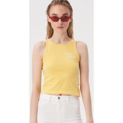 Crop top z haftowanym napisem - Żółty. Żółte topy damskie Sinsay, s, z haftami, bez kołnierzyka. W wyprzedaży za 9,99 zł.