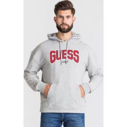 BLUZA IZZY HOODIE Guess. Szare bluzy męskie Guess, s, z haftami, z bawełny, z kapturem, bez rękawów, z kapturem. Za 369,00 zł.