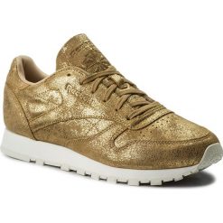 Buty Reebok - Cl Lthr Shimmer CN0574 Xj Gold/Chalk. Żółte buty sportowe damskie Reebok, na co dzień, bez wzorów, ze skóry, bez obcasa, na płaskiej podeszwie, bez zapięcia. W wyprzedaży za 269,00 zł.