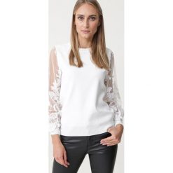 Biały Sweter Lotsanwarm. Białe swetry damskie Born2be, s, bez wzorów, eleganckie, bez rękawów, bez kaptura. Za 109,99 zł.