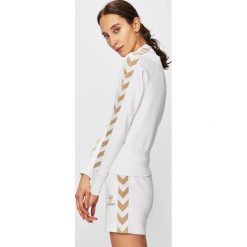 Hummel - Bluza. Białe bluzy damskie Hummel, s, z nadrukiem, z elastanu, bez rękawów, bez kaptura. W wyprzedaży za 159,90 zł.